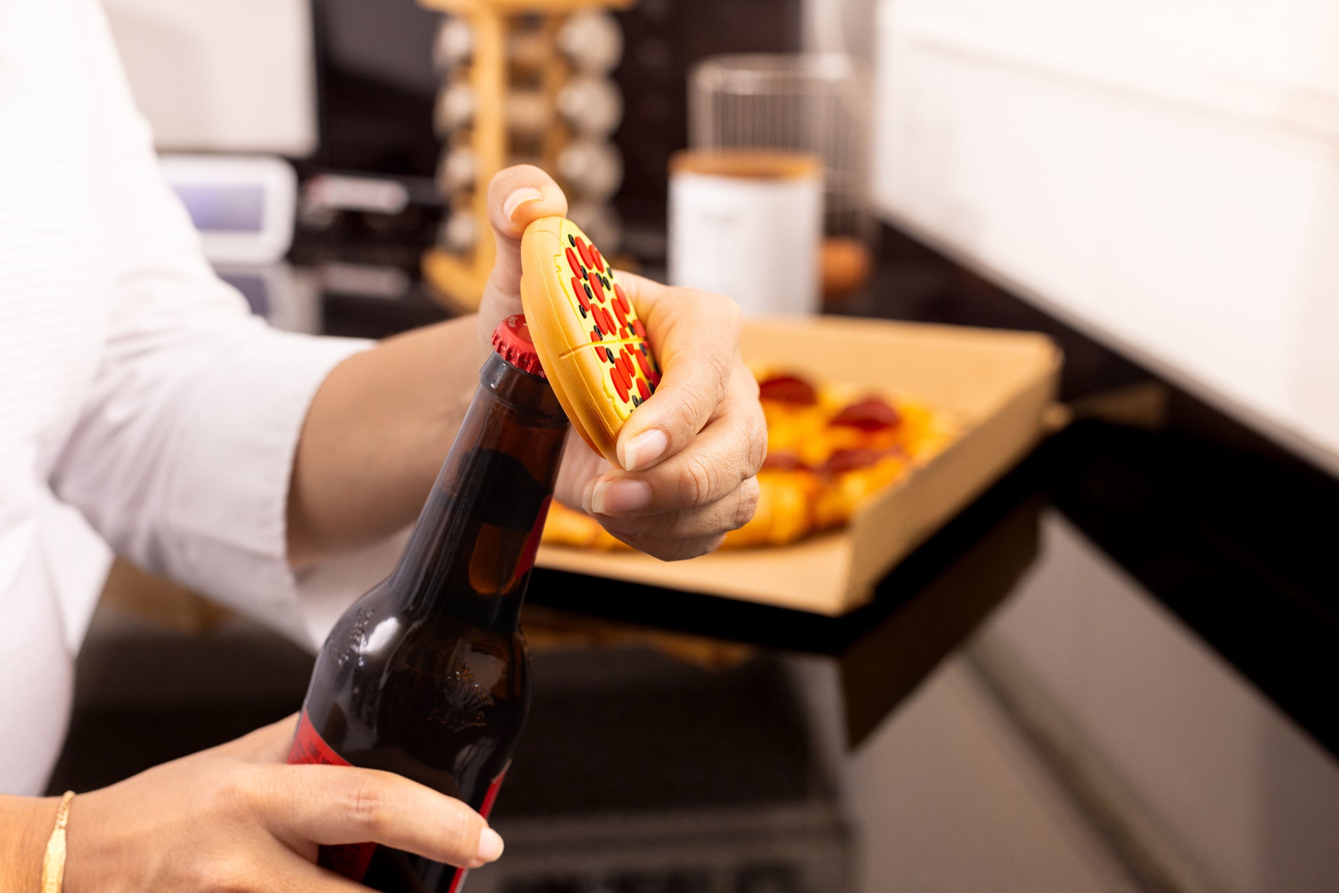 Person using pizza bottle opener on beer – fun novelty gift and kitchen tool